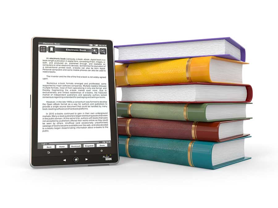 electronic reading device next to a stack of paper books